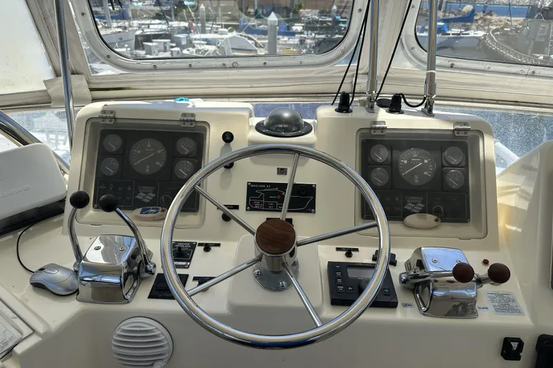 Slide: The Image of Cockpit of 1998 Mikelson 43 Sportfisher with steering wheel and control panels. - 7