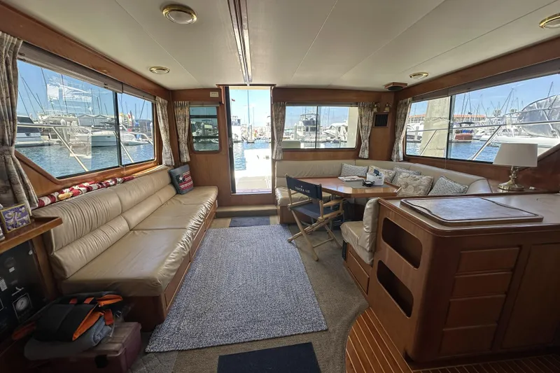 Slide: The Image of Interior of 1998 Mikelson 43 Sportfisher yacht with comfortable seating and marina view. - 12