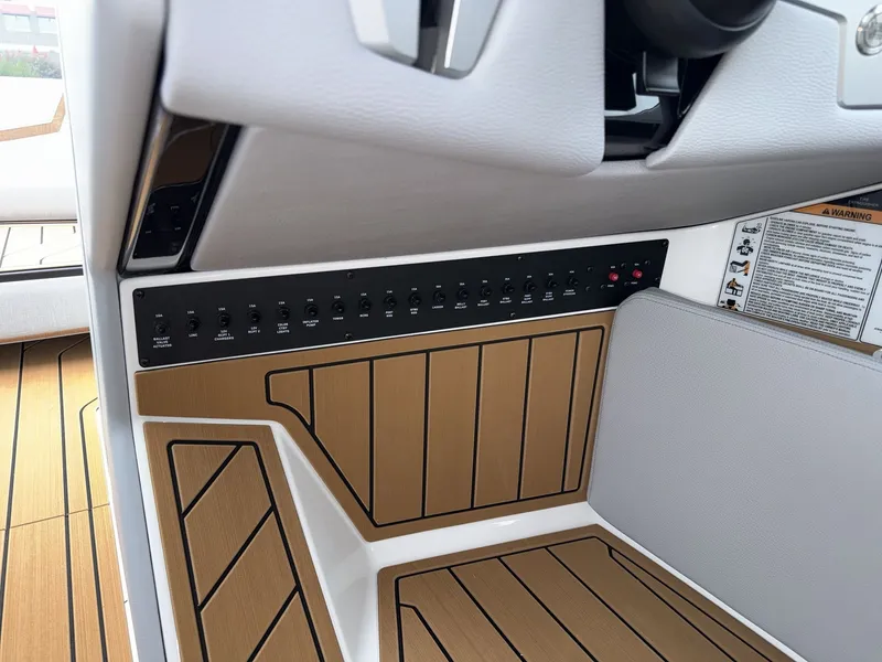 Slide: The Image of The image shows the dashboard of a Nautique G23 boat with modern controls. - 25