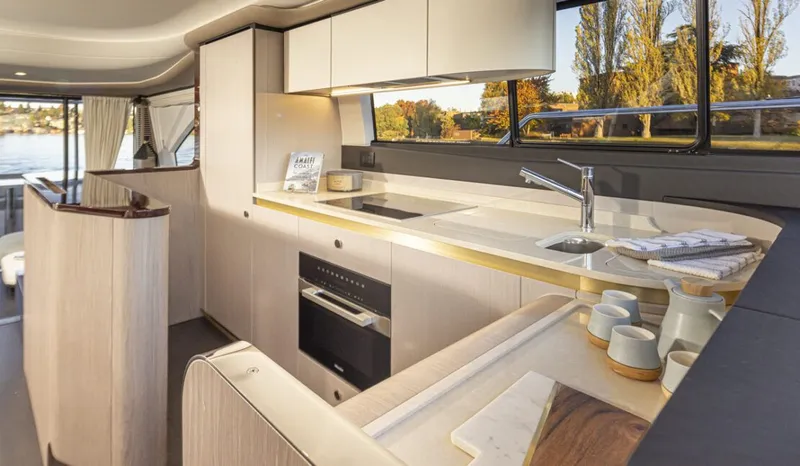 Slide: The Image of Interior of the 2023 Azimut 60 Fly with modern kitchen and large windows. - 8