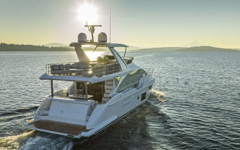 Slide: The Image of A luxurious Azimut 60 Fly yacht cruising on the water at sunset. - 1