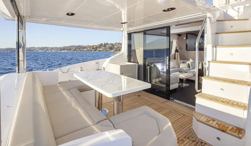 Slide: The Image of The image shows the deck of a 2023 Azimut 60 Fly with seating area and table. - 11
