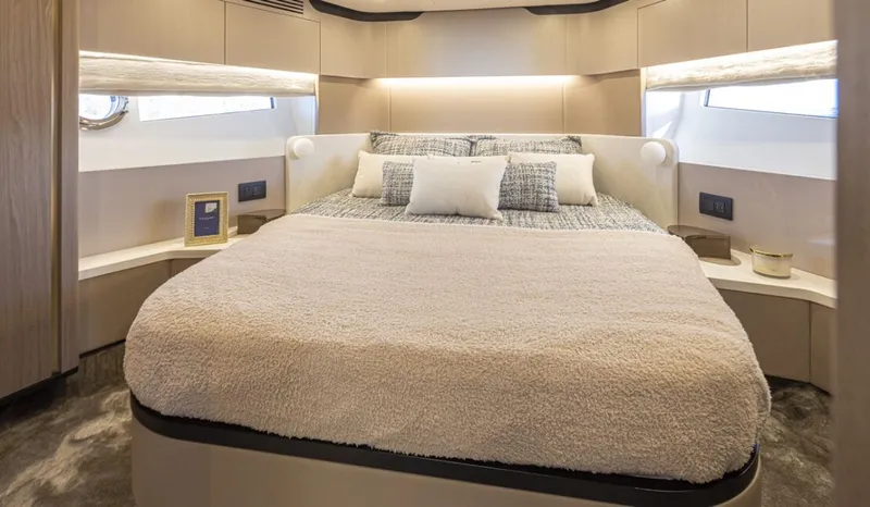 Slide: The Image of Luxurious bedroom with a large bed and modern furnishings on an Azimut 60 Fly yacht. - 13