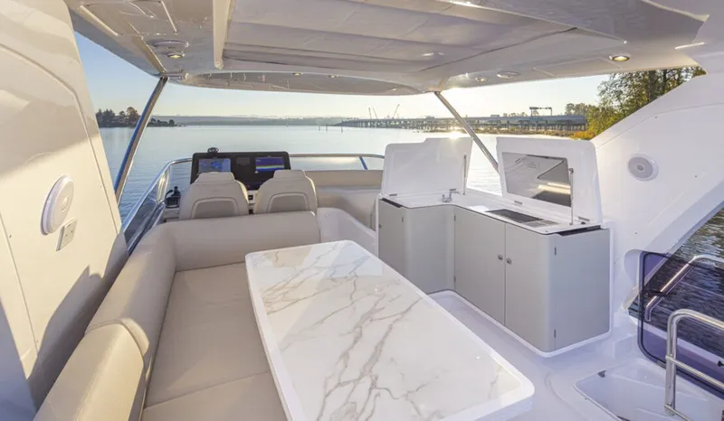 Slide: The Image of Flybridge of the Azimut 60 Fly with elegant seating area and view of the water. - 9