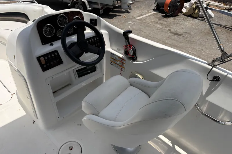 Slide: The Image of 2012 Hurricane SunDeck Sport 188 OB boat cockpit with steering wheel and controls. - 8