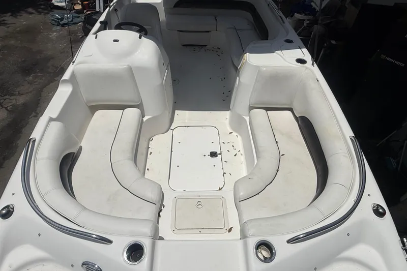 Slide: The Image of 2012 Hurricane SunDeck Sport 188 OB boat interior with spacious seating and storage compartments. - 15
