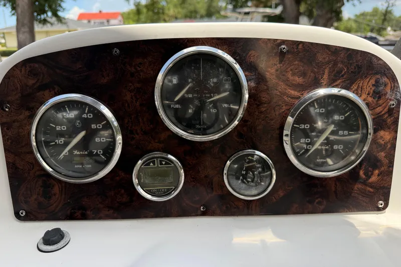 Slide: The Image of Dashboard of a 2012 Hurricane SunDeck Sport 188 OB boat with gauges and wood finish. - 9