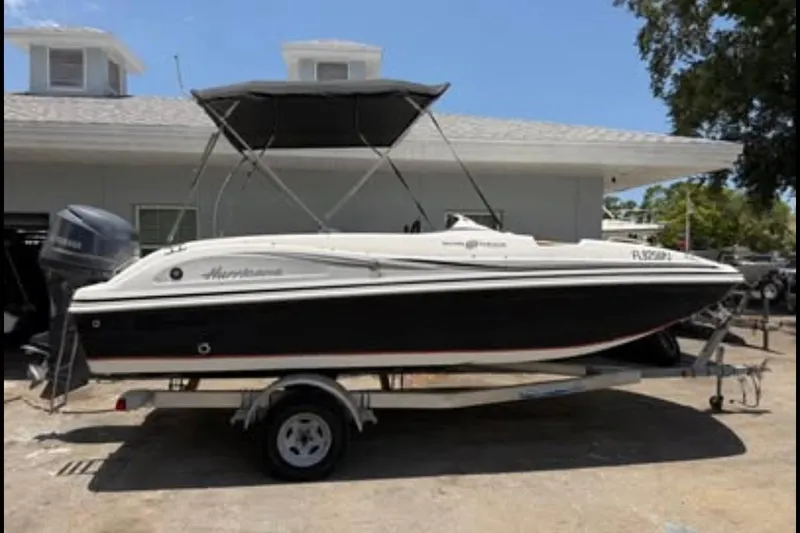 The Image of 2012 Hurricane SunDeck Sport 188 OB boat on trailer, parked outdoors. - 0