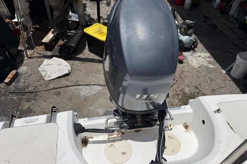 Slide: The Image of 2012 Hurricane SunDeck Sport 188 OB with Yamaha 115 outboard motor in a workshop setting. - 3