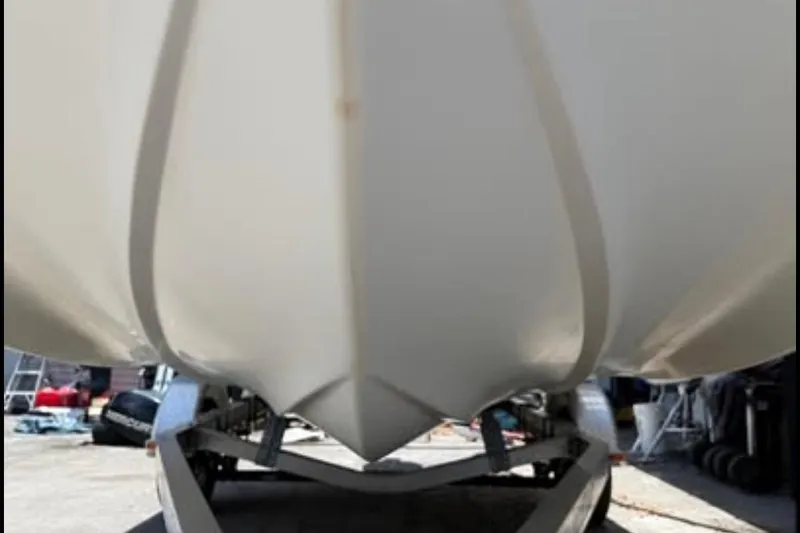 Slide: The Image of 2012 Hurricane SunDeck Sport 188 OB boat hull on trailer, viewed from below. - 2