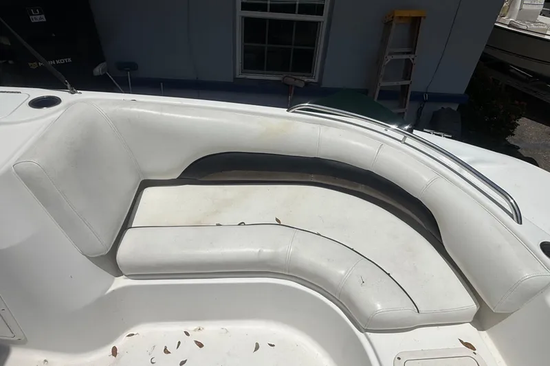 Slide: The Image of 2012 Hurricane SunDeck Sport 188 OB boat interior with white seating and cup holder. - 14