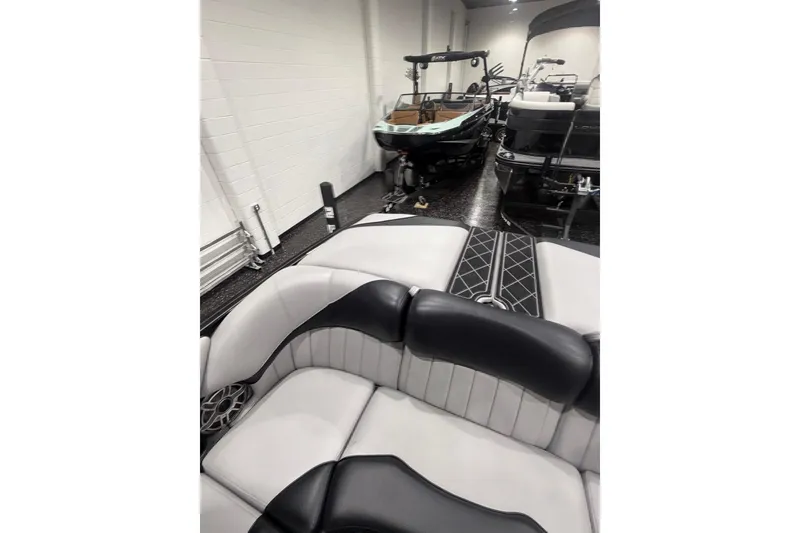 Slide: The Image of 2024 MB B52 23 Classic boat interior with sleek black and white seating in showroom. - 48