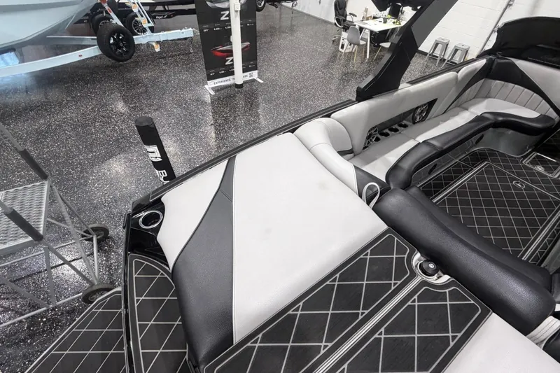 Slide: The Image of 2024 MB B52 23 Classic boat interior with sleek black and white seating design. - 52