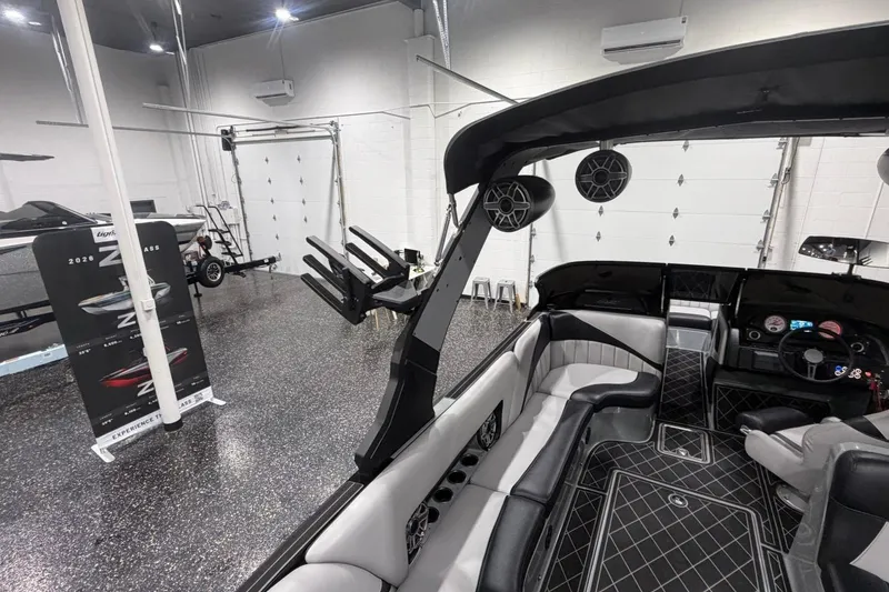 Slide: The Image of Interior of 2024 MB B52 23 Classic boat in showroom with luxury seating and speakers. - 50