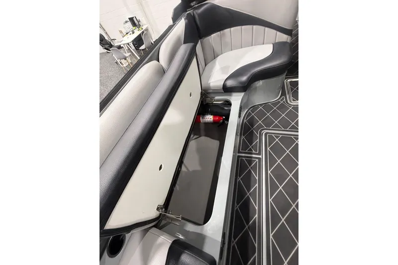 Slide: The Image of 2024 MB B52 23 Classic boat interior with storage compartment and fire extinguisher. - 66