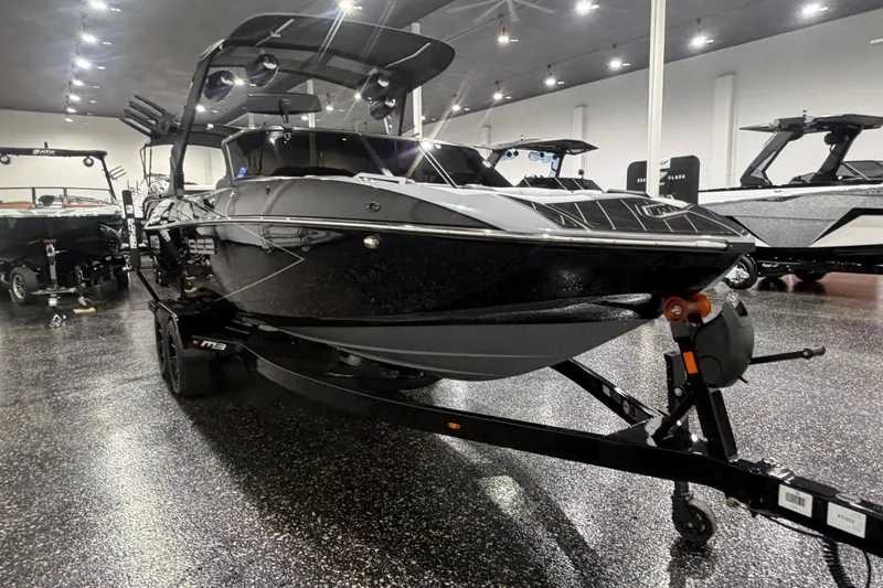 Slide: The Image of 2024 MB B52 23 Classic boat displayed in a showroom with sleek black design. - 6