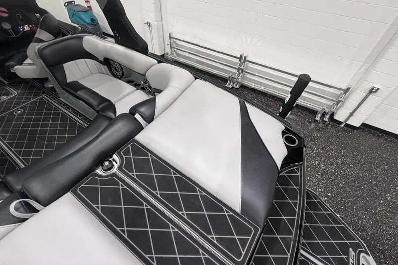 Slide: The Image of 2024 MB B52 23 Classic boat interior with black and white seating and diamond-patterned flooring. - 53