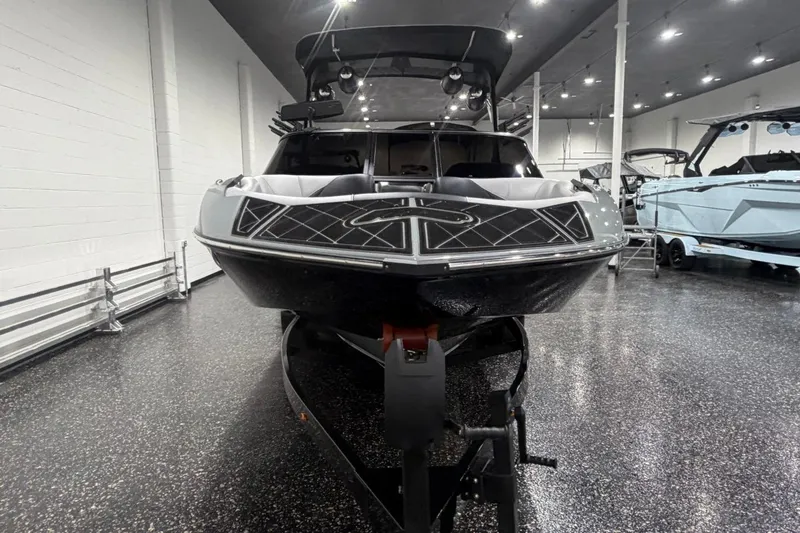 Slide: The Image of 2024 MB B52 23 Classic boat in showroom, front view, sleek design, black and silver finish. - 4