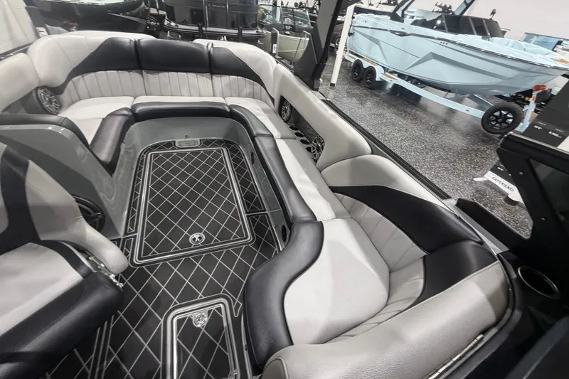 Slide: The Image of 2024 MB B52 23 Classic boat interior with luxurious seating and sleek design. - 23