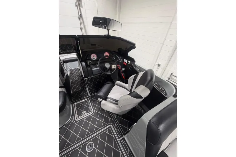 Slide: The Image of 2024 MB B52 23 Classic boat interior with modern dashboard and seating. - 28