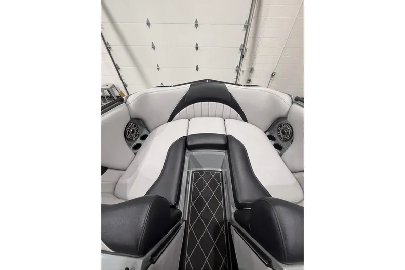 Slide: The Image of 2024 MB B52 23 Classic boat interior with black and white seating and speakers. - 12