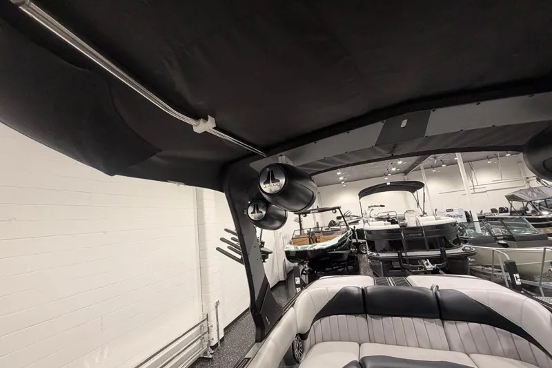 Slide: The Image of 2024 MB B52 23 Classic boat interior with speakers and seating in showroom. - 26
