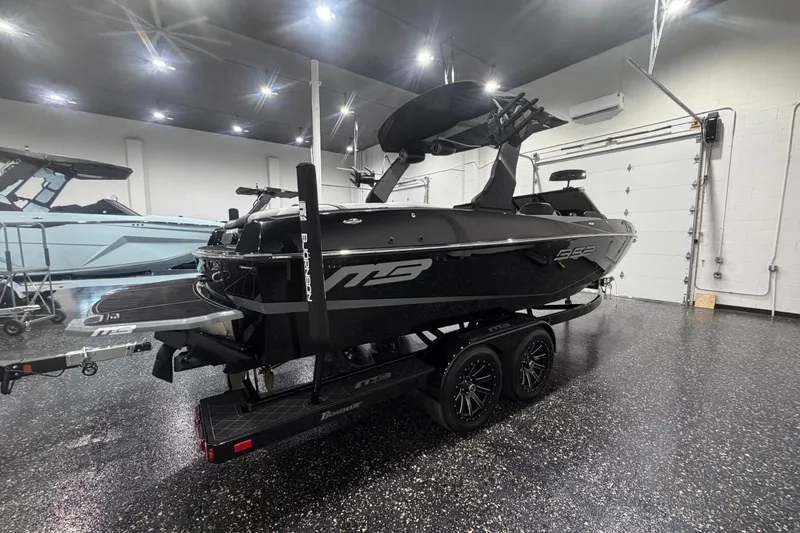 Slide: The Image of 2024 MB B52 23 Classic boat in showroom, black exterior, on trailer. - 8