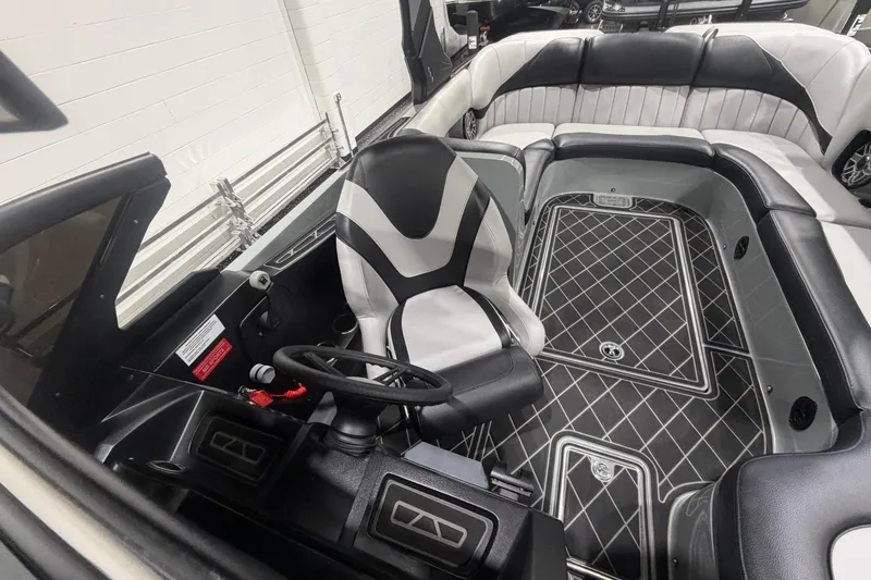 Slide: The Image of 2024 MB B52 23 Classic boat interior with sleek seating and modern steering console. - 22