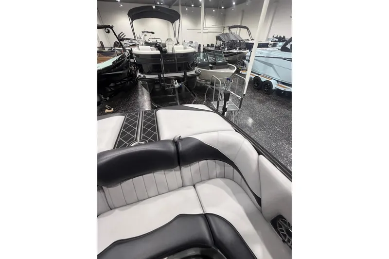 Slide: The Image of 2024 MB B52 23 Classic boat interior in showroom with other boats displayed. - 44