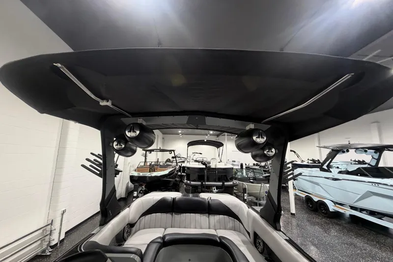 Slide: The Image of 2024 MB B52 23 Classic boat interior with speakers and seating in showroom. - 24