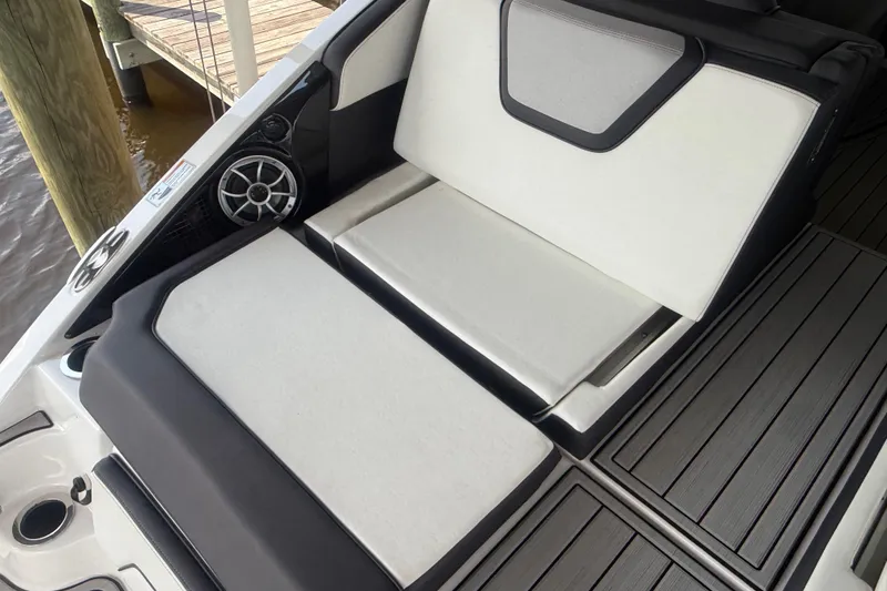 Slide: The Image of 2022 Yamaha Boats 252SD interior with cushioned seating and speaker detail. - 9
