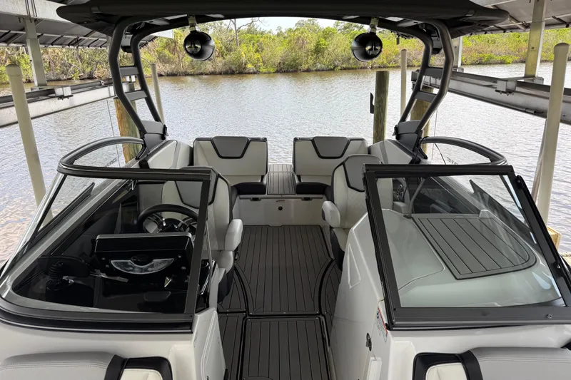 Slide: The Image of 2022 Yamaha Boats 252SD interior with sleek seating and modern dashboard design. - 52