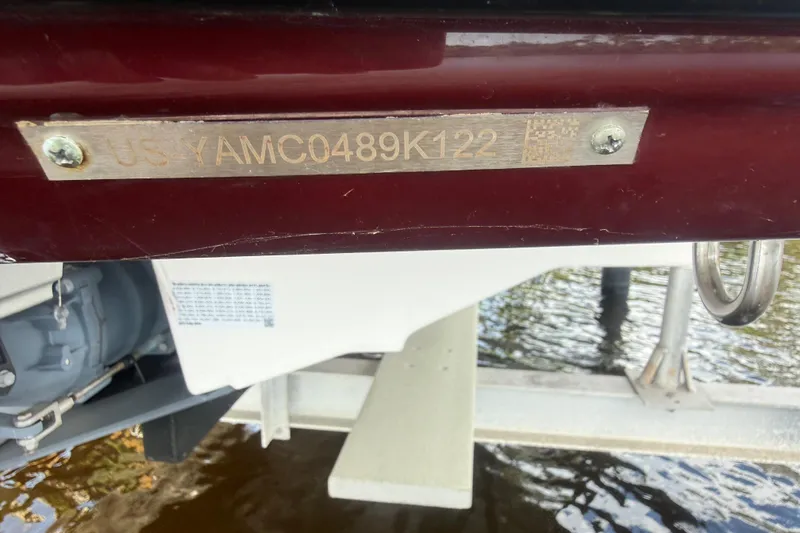 Slide: The Image of 2022 Yamaha Boats 252SD hull identification number on metal plate above water. - 73