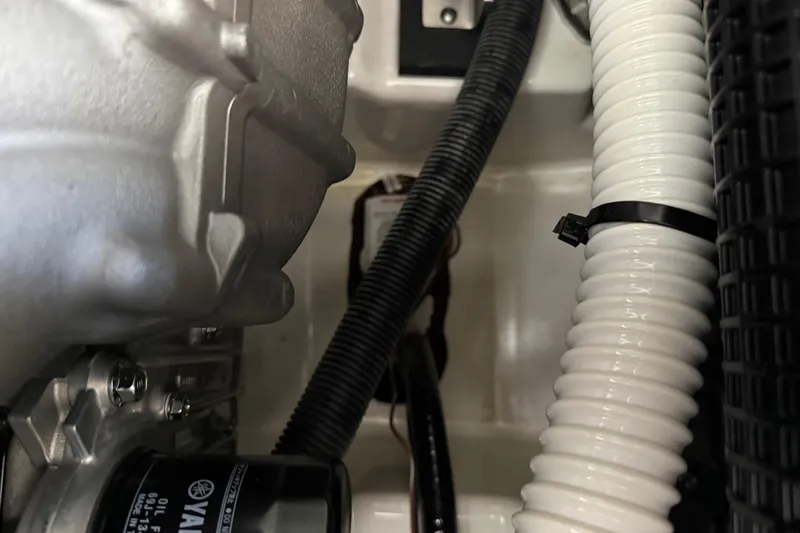 Slide: The Image of Engine compartment of 2022 Yamaha Boats 252SD, showcasing wiring and components. - 28