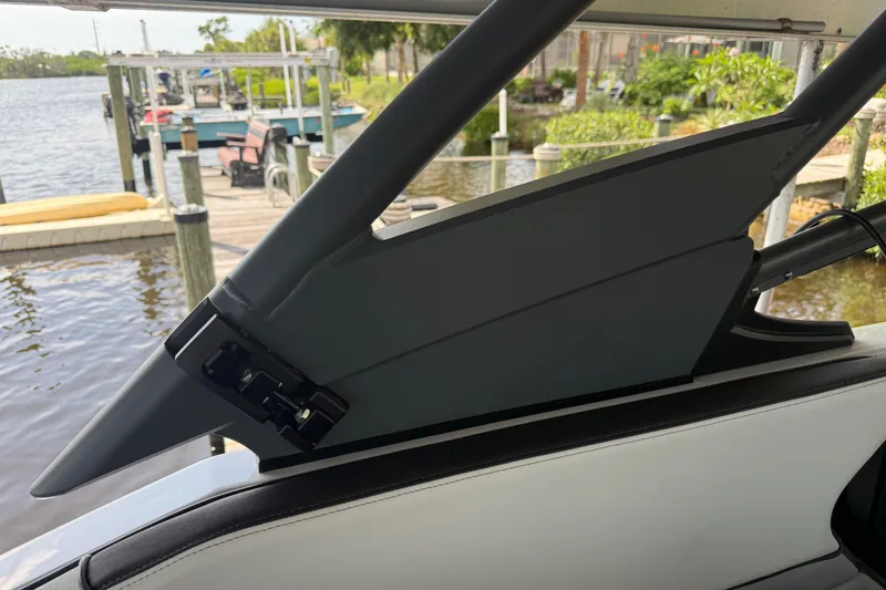 Slide: The Image of 2022 Yamaha Boats 252SD interior detail with water and dock in background. - 56