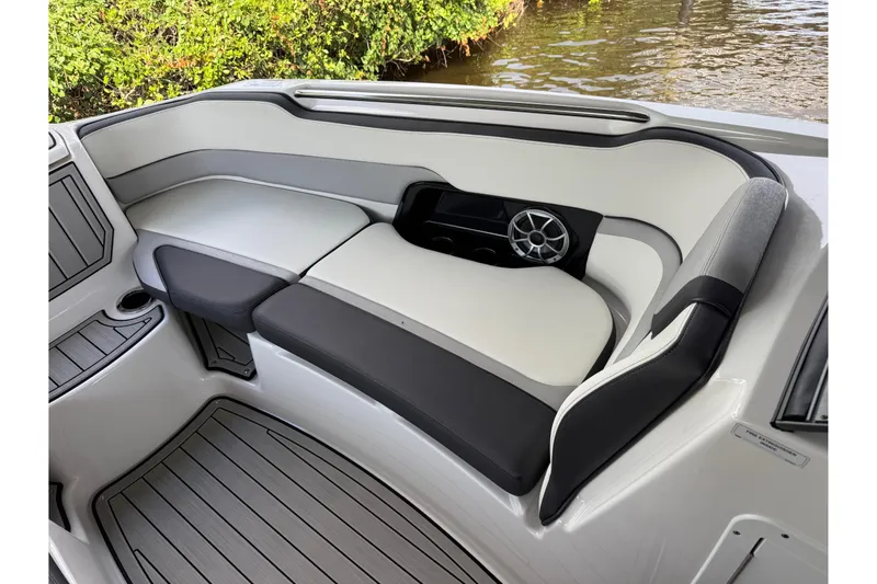 Slide: The Image of 2022 Yamaha Boats 252SD interior seating with speaker, cup holder, and sleek design. - 54