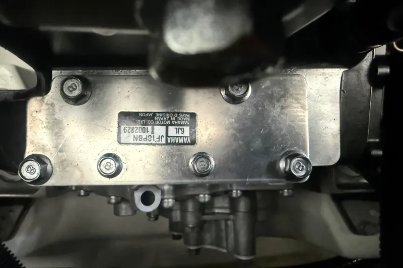 Slide: The Image of Close-up of Yamaha Boats 252SD 2022 engine component with visible bolts and label. - 71