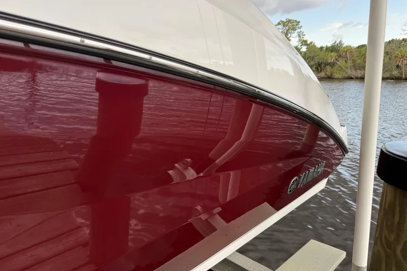 Slide: The Image of Close-up of a red Yamaha 252SD boat at the dock. - 5