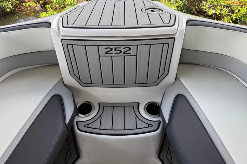 Slide: The Image of 2022 Yamaha Boats 252SD interior with sleek seating and cup holders. - 70