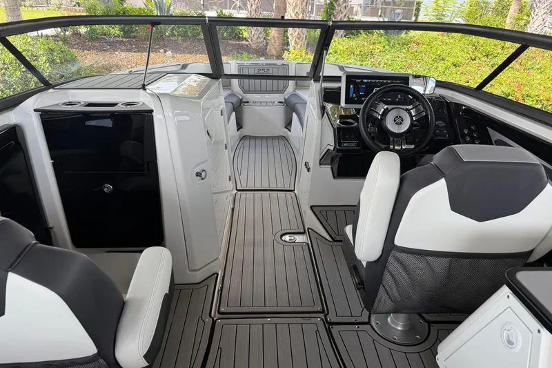 Slide: The Image of 2022 Yamaha Boats 252SD interior with sleek design and modern dashboard controls. - 29