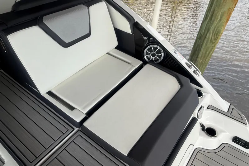 Slide: The Image of 2022 Yamaha Boats 252SD interior seating with sleek design and speaker system. - 10