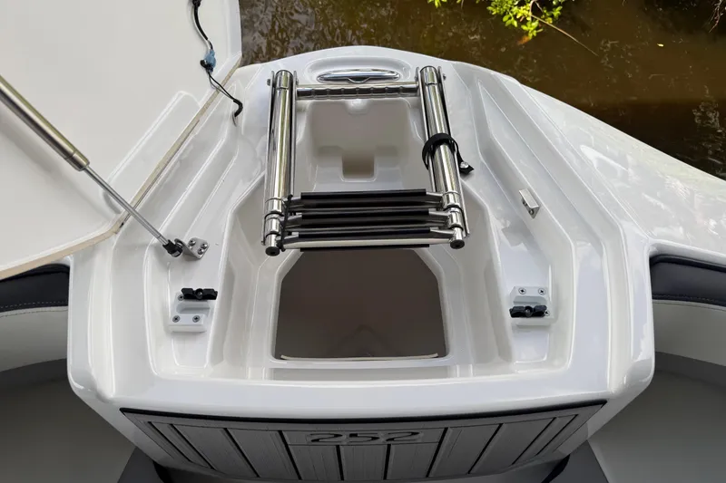 Slide: The Image of 2022 Yamaha Boats 252SD bow with ladder and storage compartment. - 69