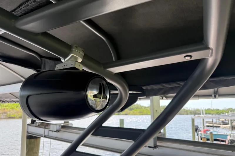 Slide: The Image of 2022 Yamaha Boats 252SD with JL Audio speaker, docked by the water. - 65