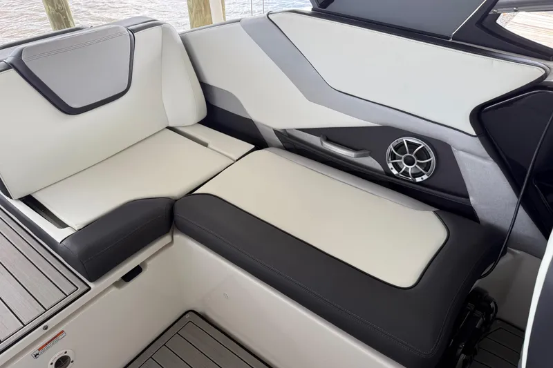 Slide: The Image of 2022 Yamaha Boats 252SD interior seating with sleek design and integrated speaker system. - 20