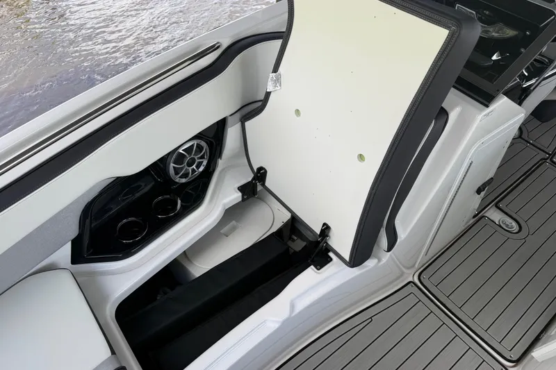 Slide: The Image of 2022 Yamaha Boats 252SD interior with storage compartment and speaker detail. - 68