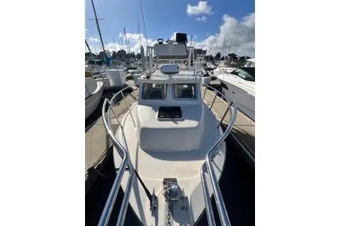 Slide: The Image of 2023 Defiance Guadalupe 290 EX boat docked at marina under clear sky. - 1