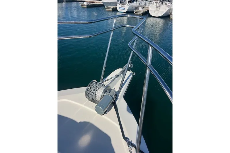 Slide: The Image of Bow of 2023 Defiance Guadalupe 290 EX boat with anchor chain and railing. - 18