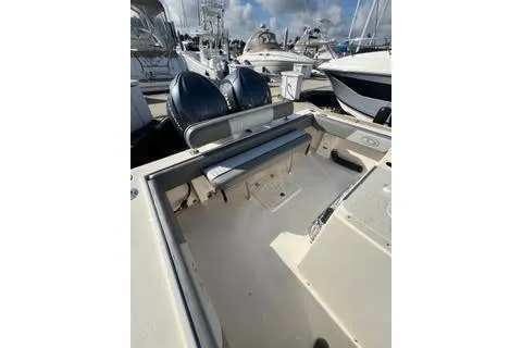 Slide: The Image of 2023 Defiance Guadalupe 290 EX boat interior with dual engines, docked at marina. - 5