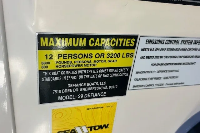 Slide: The Image of 2023 Defiance Guadalupe 290 EX capacity label: 12 persons or 3200 lbs, USCG compliant. - 24