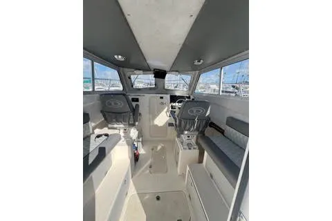 Slide: The Image of Interior view of 2023 Defiance Guadalupe 290 EX boat, featuring modern seating and controls. - 3